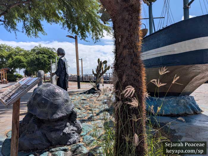 Chloris barbata making itself at home next to memorial of Charles Darwin in Puerto Baquerizo Moreno in San Cristobal in the Galapagos Islands.